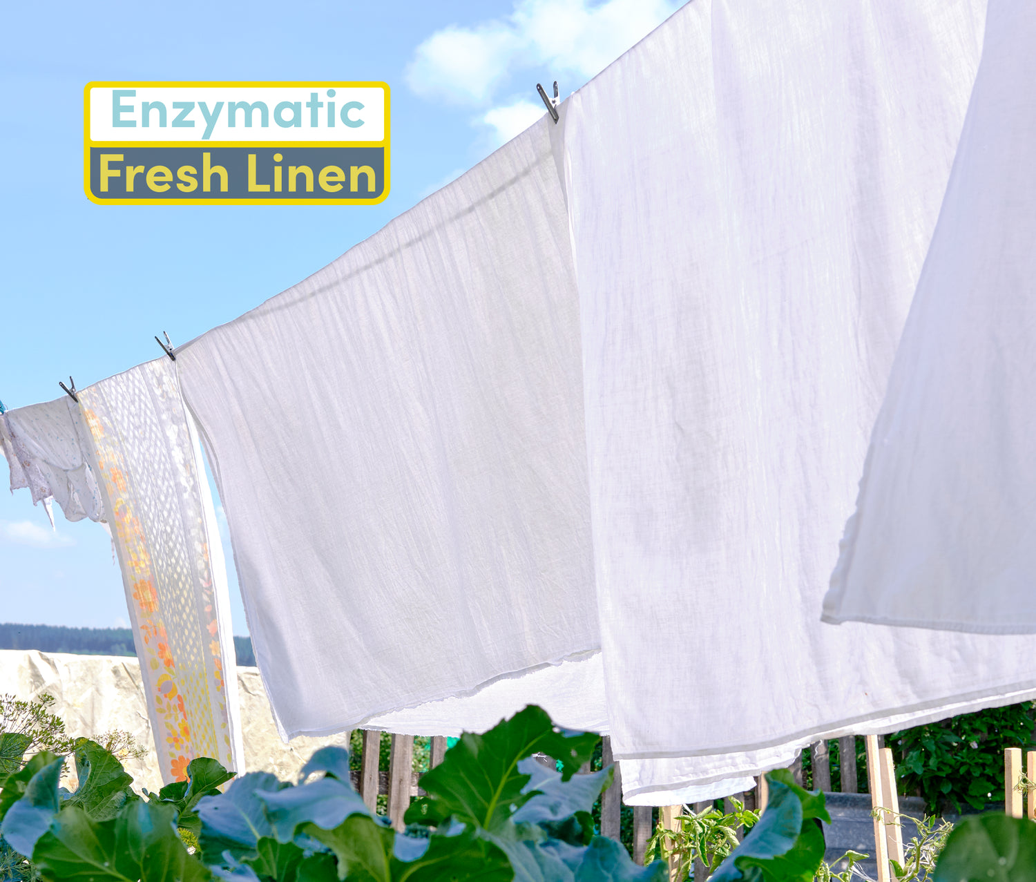 white linens hanging outside to dry on a clothes line