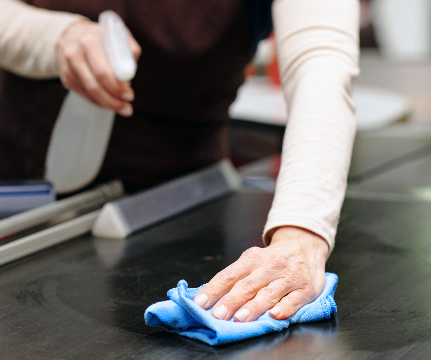 hand wiping cashier area of store